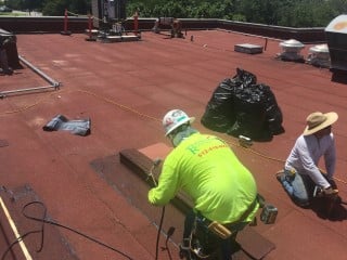 roof worker making repairs 